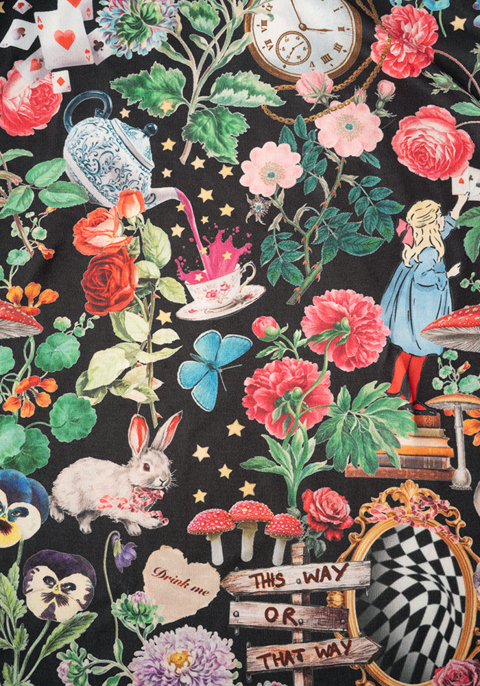 Colourful Wonderland-themed pyjamas with flowers, characters, and text on a black background.